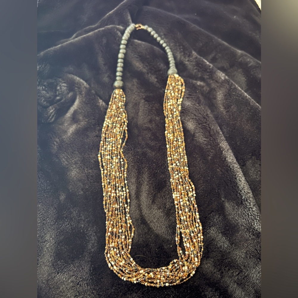 Long and versatile piece, multi brown and cream beaded necklace.